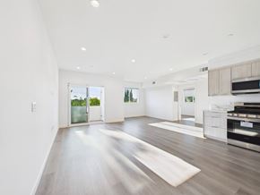 Valley Village apartment for rent - A spacious, well-lit room with a wooden floor and white walls.