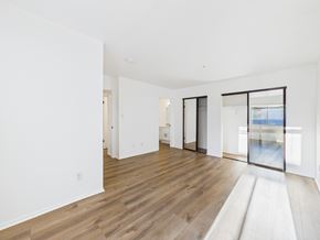 Pasadena apartment for rent - A spacious room with wooden flooring and white walls.