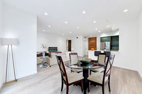 Los Angeles apartment for rent - A modern dining room with a glass table and chairs.