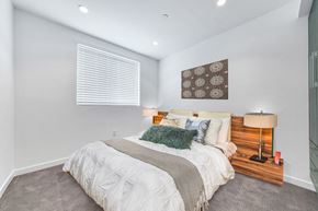 Los Angeles apartment for rent - A bedroom with a large bed and a wooden headboard.