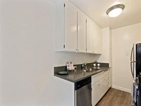 Los Angeles apartment for rent - A kitchen with white cabinets and a black dishwasher.
