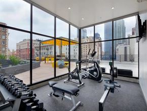 Los Angeles apartment for rent - Two-Bedroom Apartments in Downtown Los Angeles, CA - The Broadway Lofts - Modern Fitness Center With Free Weights, Cardio Machines, and Floor-To-Ceiling Windows Overlooking Downtown Skyline.
