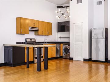 Los Angeles apartment for rent - A kitchen with wooden cabinets and a black dishwasher.
