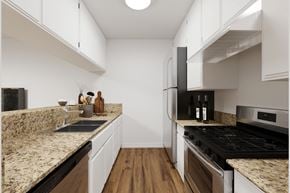 Sherman Oaks apartment for rent - a kitchen with marble counter tops and white cabinets