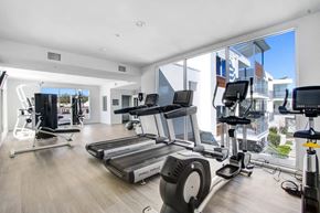 Ventura apartment for rent - a gym with cardio equipment and windows on the side of a building