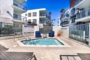 Ventura apartment for rent - an apartment pool with two chairs in front of an apartment building