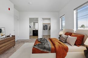 Ventura apartment for rent - a bedroom with an orange blanket and pillows on a couch