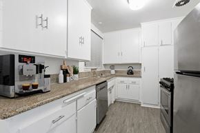 Beverly Hills apartment for rent - a kitchen with white cabinets and granite counter tops and stainless steel appliances