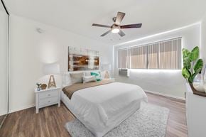 West Hollywood apartment for rent - A bedroom with a large bed and a ceiling fan.