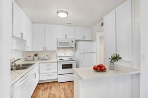 Sherman Oaks apartment for rent - A kitchen with white cabinets and appliances.