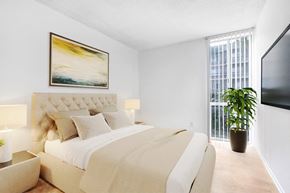 Sherman Oaks apartment for rent - A bedroom with a large bed and a painting on the wall.
