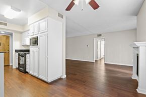 Sherman Oaks apartment for rent - an empty living room with white cabinets and a wood floor