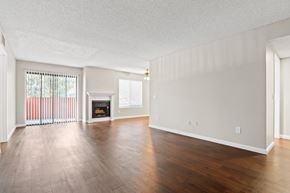Sherman Oaks apartment for rent - the spacious living room with wood flooring and a fireplace