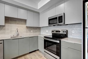 Los Angeles apartment for rent - a kitchen with gray cabinets and stainless steel appliances