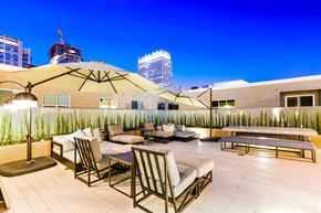 Los Angeles apartment for rent - A rooftop patio with a table and chairs.