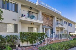 Los Angeles apartment for rent - A white building with a balcony and a door.