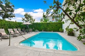 Sherman Oaks apartment for rent - A small pool surrounded by chairs and plants.
