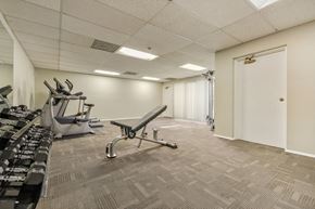 Valley Village apartment for rent - A gym with a bench, weights, and exercise equipment.