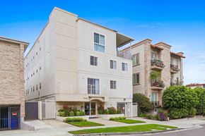Los Angeles apartment for rent - A modern two-story building with a flat roof and a balcony on the second floor.