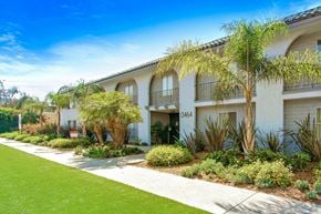 Van Nuys apartment for rent - A white building with a green lawn in front.
