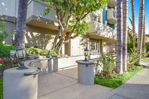 Los Angeles apartment for rent - A concrete fountain in front of a building with a tree in the background.