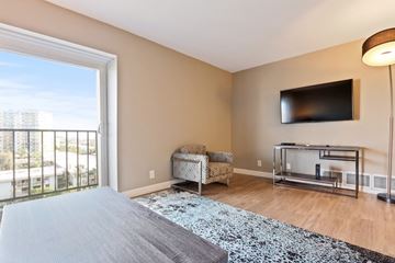 Marina Del Rey apartment for rent - A living room with a grey carpet and a flat screen TV mounted on the wall.