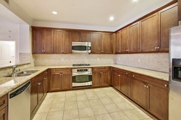 Studio City apartment for rent - A kitchen with wooden cabinets and a tiled floor.