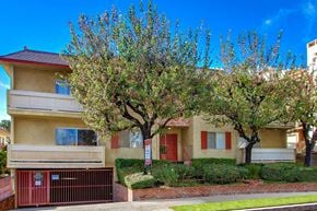 Los Angeles apartment for rent - A tree in front of a two-story building with a red door.