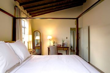 West Hollywood apartment for rent - A bedroom with a large bed and a wooden ceiling.