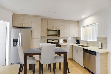 Burbank apartment for rent - A modern kitchen with a dining table and chairs.