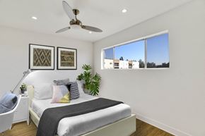 Burbank apartment for rent - A bedroom with a large bed and a ceiling fan.