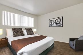 Northridge apartment for rent - A bedroom with a large bed and a painting on the wall.