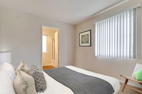 Los Angeles apartment for rent - A bedroom with a bed, pillows, and a picture on the wall.