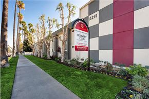 Van Nuys apartment for rent - A Country Club sign is on a pole in front of a building.