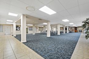 Placentia apartment for rent - A spacious room with a carpeted floor and white columns.
