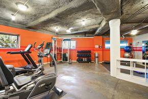 Brentwood apartment for rent - A gym with orange walls and a variety of exercise equipment.