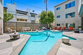 Brentwood apartment for rent - A swimming pool with a sun lounger and a table.