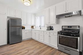 Los Angeles apartment for rent - A kitchen with white cabinets and a stainless steel refrigerator.