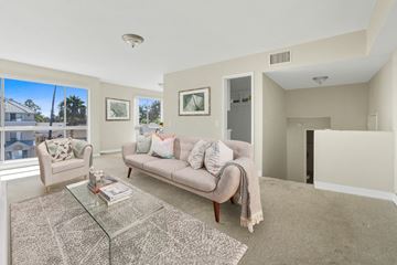 Los Angeles apartment for rent - A living room with a glass coffee table and a couch with a throw blanket on it.