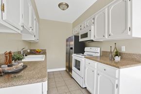 Los Angeles apartment for rent - A kitchen with white cabinets and appliances.