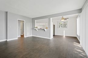Los Angeles apartment for rent - A spacious room with a ceiling fan and hardwood floors.