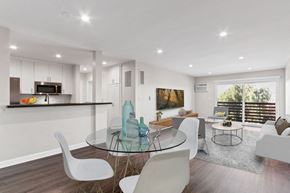 Los Angeles apartment for rent - A modern dining room with a glass table and white chairs.