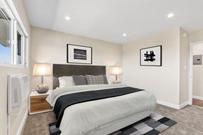 Los Angeles apartment for rent - A bedroom with a large bed and two lamps.