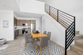 San Pedro apartment for rent - A modern dining room with a wooden table and grey chairs.