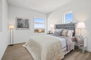 San Pedro apartment for rent - A bedroom with a large bed and a window overlooking the city.