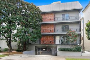 Los Angeles apartment for rent - A building with a red brick facade and a white facade with balconies.