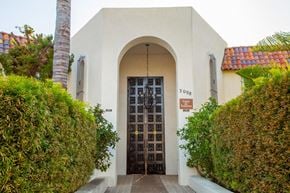 Ventura apartment for rent - a building with a door and a palm tree
