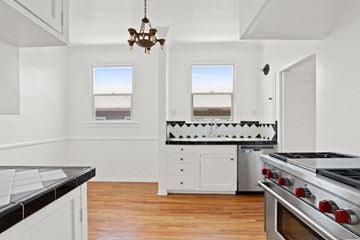 Los Angeles apartment for rent - A kitchen with a black counter top and white cabinets.