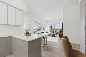Culver City apartment for rent - A kitchen with white cabinets and a large island with a plant on it.