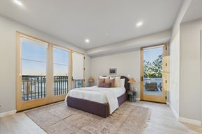 Los Angeles apartment for rent - A bedroom with a large bed and a view of the ocean through the sliding glass doors.